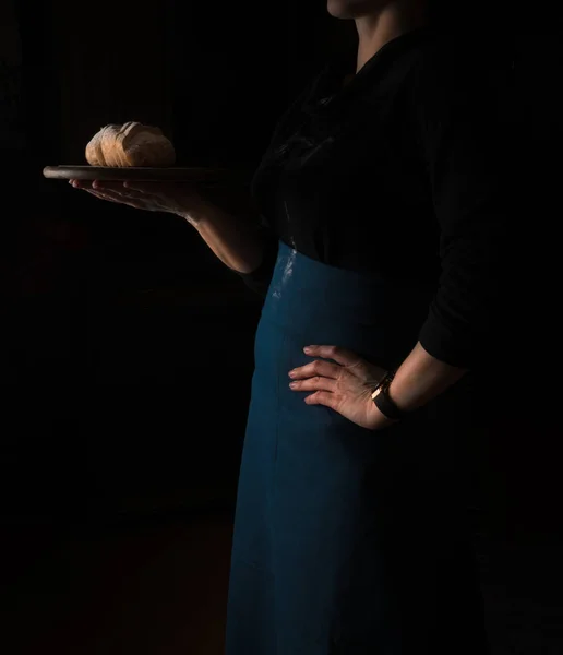 Still life in the small Dutch-style. a woman holding  tray of bread. vintage — Stock Photo, Image