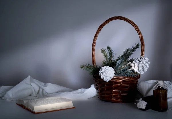 New Year, Christmas. basket with fir branches and cones on a table in the twilight