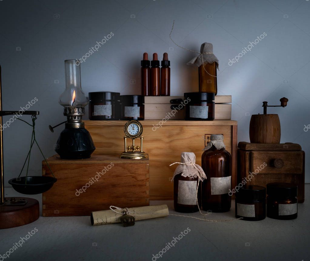 alchemy lab bottles jars scales a kerosene lamp on wooden