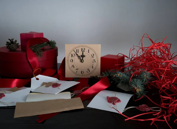 Christmas background with clock, snow fir tree and gift boxes over wood. letters invitations Santa Claus