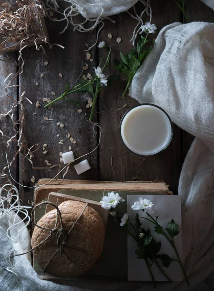 Still life, vintage. old books, a glass of milk, cakes, drapery on  wooden table. top view — Stock Photo, Image