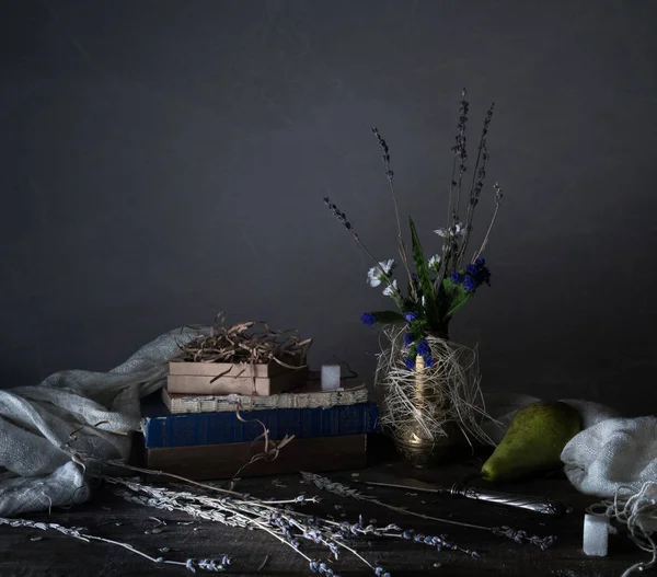 Still life, vintage. old books, bouquet of flowers, drapery on a wooden table. dark backgrounds — Stock Photo, Image