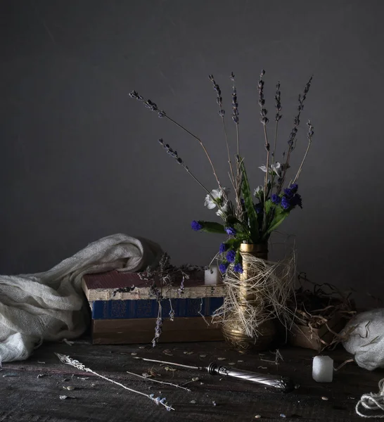 Stilleven, vintage. oude boeken, boeket bloemen, gordijnen op een houten tafel. donkere achtergronden — Stockfoto