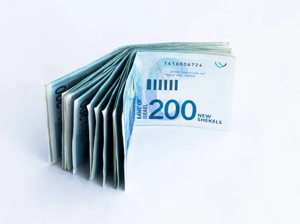 Several new banknotes worth 200 Israeli new shekels on a white — Stock Photo, Image