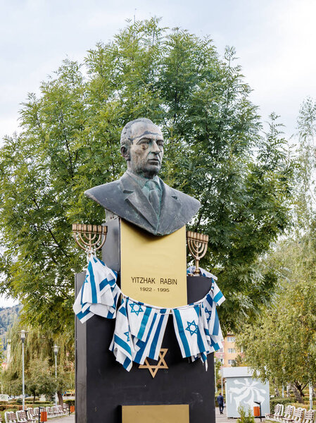 Monument to Yitzhak Rabin - the Prime Minister of the State of Israel - established with flags of Israel, in park of Brasov in Romania