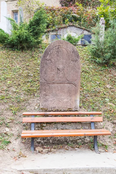 Tombstone with an erased inscription on the old cemetery located in the castle in Old City.  Sighisoara city in Romania — Stock Photo, Image