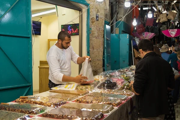 Il venditore vende dolci al cliente sul mercato nel centro storico di Acri in Israele — Foto Stock