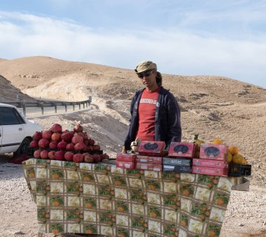  Bedevi Mitzpe Yeriho İsrail yakınındaki görüntüleme platformu üzerinde turistler için taze ve kurutulmuş meyve satıyor