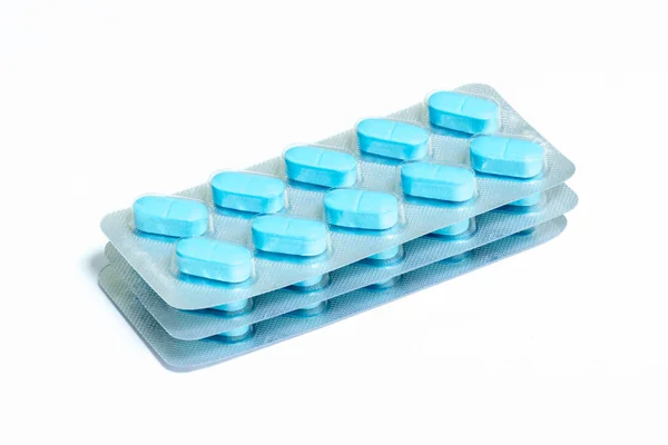 Três novos pacotes de 10 comprimidos oblongos azuis isolados em um fundo branco — Fotografia de Stock