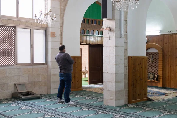 A believing muslim prays in The White Mosque - Al-Abiad in the old city of Nazareth in Israel — Stock Photo, Image