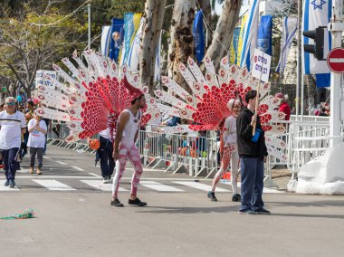 Katılımcılar carnival Nahariyya İsrail'in bir tavuskuşu takım elbise giymiş Adloyada