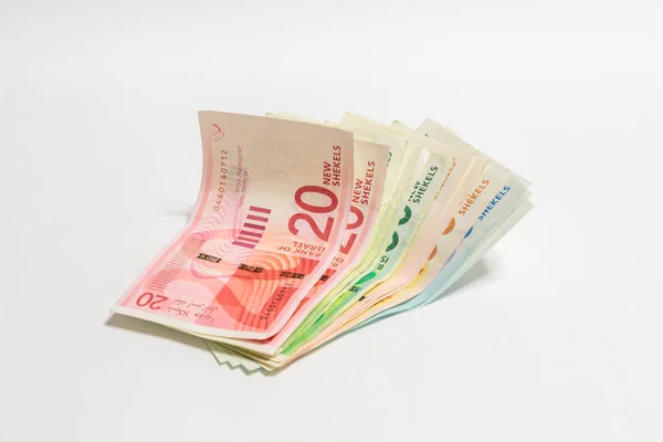 Israeli money stack of new Israeli banknotes of different value in shekels (NIS) isolated on a white background — Stock Photo, Image