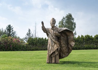 Bronze monument to Pope John Paul II on the lawn in front of the facade of the House of Galilee - Domus Galilaeae - near Vered Hagalil, Israel clipart