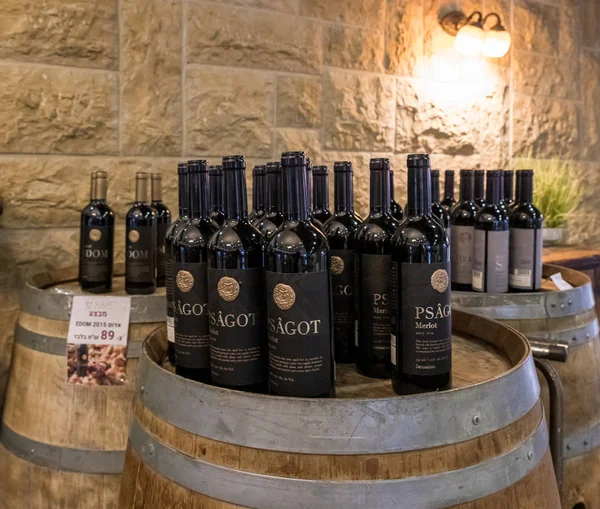 Wine bottles of Psagot winery stand on wine barrels in the visitor center in Samaria region in Benjamin district, Israel — 스톡 사진