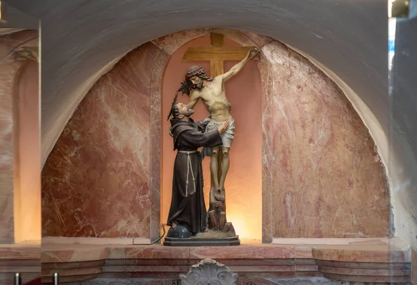 The statue of Elijas the prophet and crucified Jesus Christ stands in a niche above the entrance to the grotto of the Milk Grotto Church in Bethlehem in Palestine — 스톡 사진