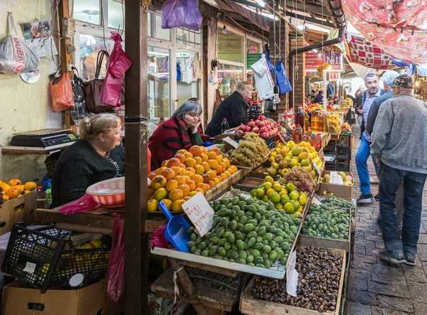 Sellers are sitting near their fruit stands in the market in the old part of Kutaisi in Georgia — 스톡 사진