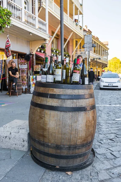 Tourist attraction - a barrel with empty bottles of Georgian wine is standing on the street inTbilisi city in Georgia — 스톡 사진