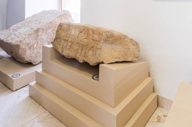 Stone with words engraved on it in mixed script - Paleo-Hebrew and Aramic inscription from Mount Gerizim - exhibit of the Museum of the Good Samaritan near Jerusalem in Israel