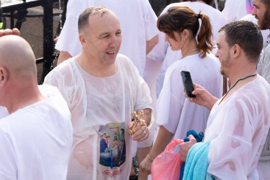 Jericho, Israel, January 18, 2020 : Believer with a cross in his hands is on the Baptismal Site of Jesus Christ near Jericho in Israel