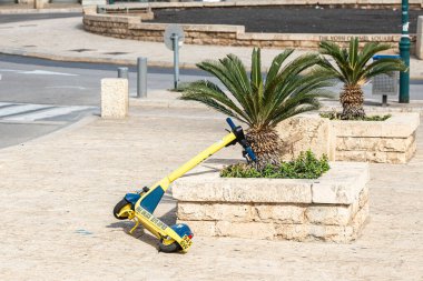 Tel Aviv-Yafo, Israel, February 01, 2020 : Electric scooter rental service lies on the sidewalk in the Yossi Carmel Square in old Yafo in Israel