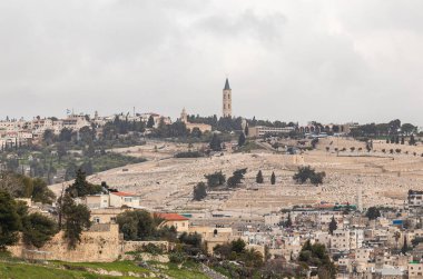 Jerusalem, Israel, February 29, 2020 : View of the old city of Jerusalem, jewish cemetery and the The Russian Church on Mount Eleon from the Abu Tor district of Jerusalem city in Israel
