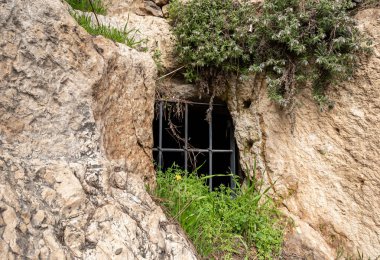 Jerusalem, Israel, February 29, 2020 : Ritual cave for burial in the Gey Ben Hinnom Park - called in the Holy Books as the Blazing Inferno in Jerusalem city in Israel