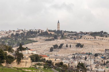 Jerusalem, Israel, February 29, 2020 : View of the old city of Jerusalem, jewish cemetery and the The Russian Church on Mount Eleon from the Abu Tor district of Jerusalem city in Israel