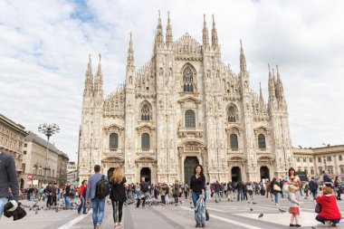 Milan, İtalya - 29 Eylül 2015: Milano, İtalya 'da Milano Katedrali' nin önündeki Piazza del Duome Meydanı boyunca çok sayıda turist ve gezgin yürüyor.
