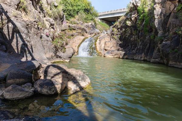 Mountain Saar Falls with cold and crystal clear water descends from a crevice in the mountains of the Golan Heights in Israel.