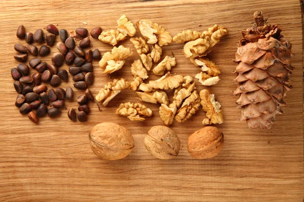 Walnut and pine nuts on a cutting board