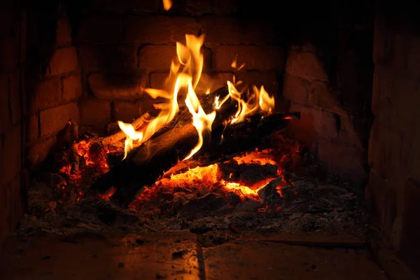 fire in fireplace/ brick fireplace with burning firewood in it