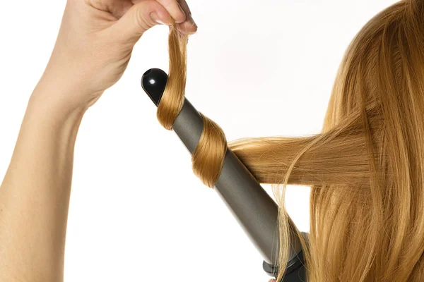 Mulher faz um cabelo ondulado sozinha — Fotografia de Stock