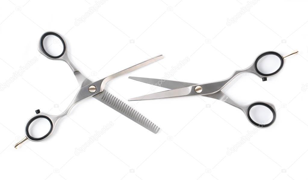 Two professional haircutting scissors isolated on white, with clipping path