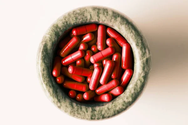 Capsules rouges et pilules orange avec pilons de mortier sur fond blanc . — Photo