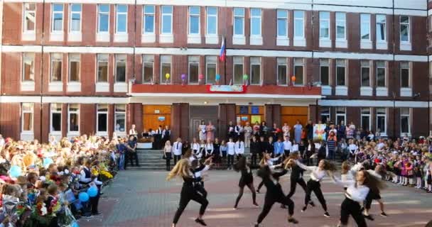 Estudiantes de secundaria realizan un baile para estudiantes de primer grado en el día abierto de las escuelas — Vídeos de Stock