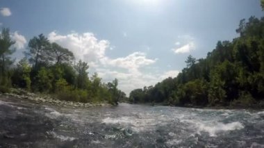 Tekneyle dağ nehrinde rafting yapmak. Birinci şahıs vuruldu.