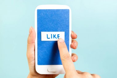 Mavi düğme gibi telefon genel kavram üzerinde itin. El kağıt smartphone gibi kelime üstünde belgili tanımlık perde ile tutarak.