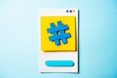 Hashtag symbol post note with paper smart phone concept on blue 