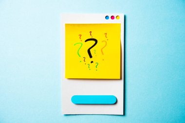 Question mark with paper smart phone concept on blue background.