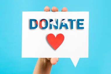 Donation and hand help concept with heart shape on speech bubble