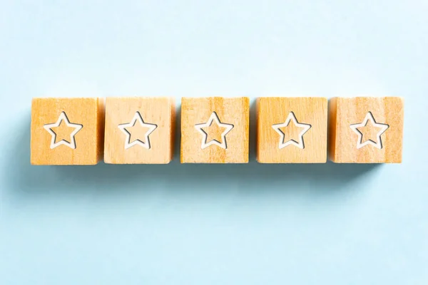 White five stars illustrated on wood blocks toy and blue backgro — 스톡 사진