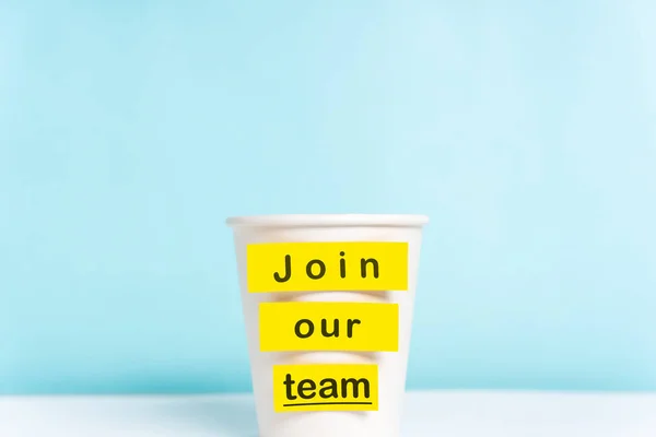 Concept of join our team or onboarding process. Paper cup with y