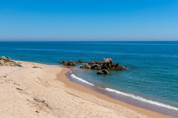 Empty sandy bay at Sant Pol de Mar nudist beach near Barcelona and Cost Brava at the times of coronavirus lockdown