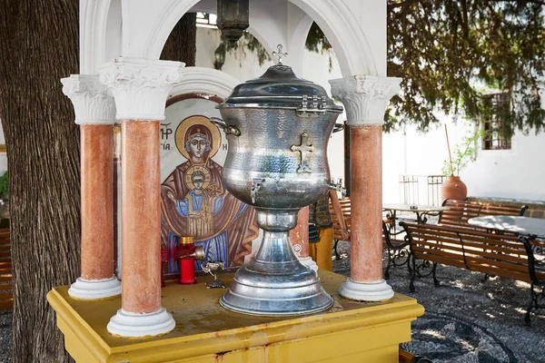 Big metal cup with holy water in the christian Tsambika church