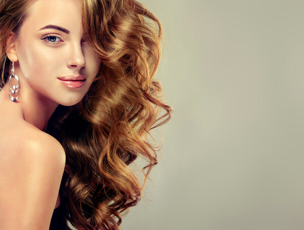 Beautiful girl with long wavy    hair .