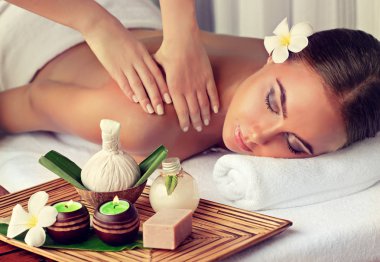 Woman having massage in the spa salon clipart
