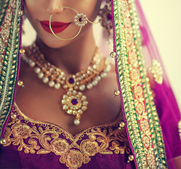 Portrait of beautiful indian girl. Young hindu woman model with kundan jewelry set. Traditional India costume lehenga choli or sari