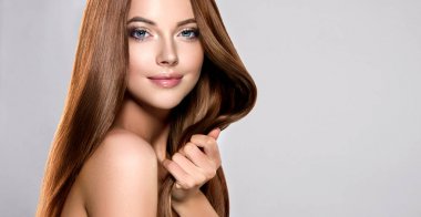 Beautiful model girl with shiny brown straight long  hair . Care and hair products . clipart