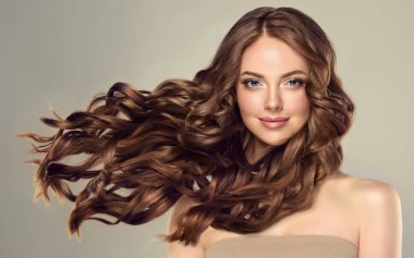 Uzun ve parlak dalgalı kaş saçlı güzel esmer kız. Kıvırcık saçlı güzel bir kadın model. .