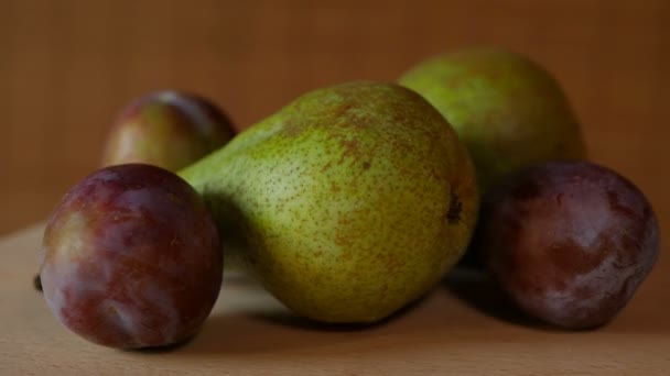 Gedeelte van pruimen en peren op plaat hout draaien — Stockvideo